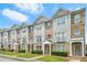 Attractive townhome exterior featuring stone accents, siding, and well-maintained front yard landscaping at 5529 Festival Ave, Fairburn, GA 30213