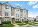 Attractive townhome exterior featuring stone accents, siding, and well-maintained front yard landscaping at 5529 Festival Ave, Fairburn, GA 30213