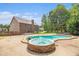 Backyard oasis featuring a pool, hot tub, and a covered cabana at 6086 Willowpond Ct, Douglasville, GA 30135