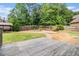 Sprawling backyard featuring a spacious lawn, a built-in grilling area, and mature trees for privacy at 6086 Willowpond Ct, Douglasville, GA 30135