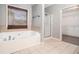 Large soaking tub in bathroom with a glass shower and a view to a walk-in closet at 6086 Willowpond Ct, Douglasville, GA 30135