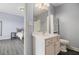Bathroom vanity with a large mirror and open doorway to a bedroom with wood-look flooring at 6086 Willowpond Ct, Douglasville, GA 30135