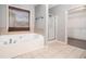 Bathroom featuring a soaking tub, walk-in shower and tile floor at 6086 Willowpond Ct, Douglasville, GA 30135