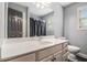 Bathroom with a spacious vanity, large mirror, white toilet, and walk-in shower at 6086 Willowpond Ct, Douglasville, GA 30135