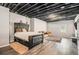 Spacious bedroom with wood-look floors, exposed ceiling, neutral paint and comfortable furniture at 6086 Willowpond Ct, Douglasville, GA 30135