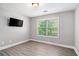 Neutral bedroom featuring grey walls, updated wood-look flooring and a large, bright window at 6086 Willowpond Ct, Douglasville, GA 30135