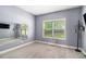 Light-filled bedroom with soft carpet, a large window, and neutral tones, creating a cozy and inviting space at 6086 Willowpond Ct, Douglasville, GA 30135