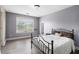 Cozy bedroom with a large window, hardwood floors, and a comfortable bed, perfect for restful nights at 6086 Willowpond Ct, Douglasville, GA 30135