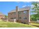 Exterior side view of a two-story house showcasing mature trees, green lawn and summer sky at 6086 Willowpond Ct, Douglasville, GA 30135