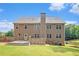 Exterior of a two-story house in the summer with a deck, fenced yard and well-kept lawn at 6086 Willowpond Ct, Douglasville, GA 30135