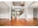 Elegant foyer with gleaming hardwood floors, wainscoting, and an open staircase at 6086 Willowpond Ct, Douglasville, GA 30135
