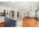 Open concept kitchen boasts granite counters, island, and stainless steel refrigerator at 6086 Willowpond Ct, Douglasville, GA 30135