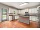 Spacious kitchen features white cabinets, stainless steel appliances, and a center island at 6086 Willowpond Ct, Douglasville, GA 30135