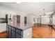 Open-concept kitchen with stainless steel appliances, a large island, granite countertops, and hardwood floors at 6086 Willowpond Ct, Douglasville, GA 30135