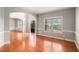 Bright living room featuring hardwood floors, large windows, and an open layout, perfect for entertaining at 6086 Willowpond Ct, Douglasville, GA 30135