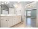 Main bathroom featuring double sinks, modern fixtures, and a view into the spacious bedroom at 6086 Willowpond Ct, Douglasville, GA 30135