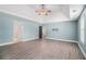 Spacious main bedroom with a tray ceiling, hardwood-style floors, and open doorways at 6086 Willowpond Ct, Douglasville, GA 30135