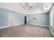 Spacious primary bedroom with trey ceiling, fan, wood look floors and access to more rooms at 6086 Willowpond Ct, Douglasville, GA 30135