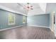Spacious primary bedroom with trey ceiling, fan and wood look floors at 6086 Willowpond Ct, Douglasville, GA 30135