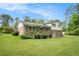 Backyard view of brick home with lush lawn, perfect for outdoor enjoyment and entertainment at 757 Tall Deer Dr, Fairburn, GA 30213