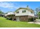 Spacious green backyard featuring a brick and white sided home with mature trees and landscaping at 757 Tall Deer Dr, Fairburn, GA 30213