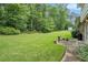 Expansive backyard featuring a well-kept lawn, trees, and a patio area for outdoor enjoyment at 757 Tall Deer Dr, Fairburn, GA 30213