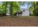 View of the home's backyard, showcasing a deck and lush trees at 856 Bridgewater Sw St, Atlanta, GA 30310