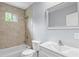 Updated bathroom features tiled shower/tub, modern vanity and mirror, and natural light at 856 Bridgewater Sw St, Atlanta, GA 30310