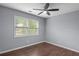 Bedroom featuring a ceiling fan, two windows for natural light, and hardwood floors at 856 Bridgewater Sw St, Atlanta, GA 30310