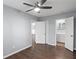 Bedroom with a ceiling fan, open doorways, and wood-look laminate flooring at 856 Bridgewater Sw St, Atlanta, GA 30310