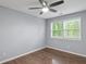 Bedroom featuring a ceiling fan, window, and wood-look laminate flooring at 856 Bridgewater Sw St, Atlanta, GA 30310