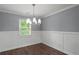 Formal dining area with wainscoting, chandelier, and natural light at 856 Bridgewater Sw St, Atlanta, GA 30310