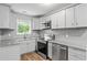 Updated kitchen with stainless steel appliances, granite countertops, and white cabinetry at 856 Bridgewater Sw St, Atlanta, GA 30310