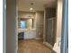 An en suite bathroom with a double sink vanity, shower and tile flooring at 125 Villa Park Cir, Stone Mountain, GA 30087
