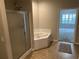 The corner of an en suite bathroom with a shower and soaking tub at 125 Villa Park Cir, Stone Mountain, GA 30087