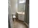 Bathroom featuring a single sink vanity, toilet, and walk-in shower at 125 Villa Park Cir, Stone Mountain, GA 30087
