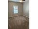 Cozy bedroom featuring carpet flooring, a ceiling fan, and a window with modern shutters at 125 Villa Park Cir, Stone Mountain, GA 30087