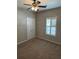 Bedroom featuring carpet flooring, window with shutters, and a ceiling fan at 125 Villa Park Cir, Stone Mountain, GA 30087