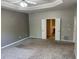 A bedroom with carpet, neutral walls and a door leading to the en suite bathroom at 125 Villa Park Cir, Stone Mountain, GA 30087