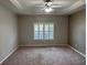 A spacious bedroom with carpet, trey ceiling with fan, window with white shutters and neutral walls at 125 Villa Park Cir, Stone Mountain, GA 30087