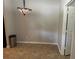 Small breakfast nook or dining area featuring tile floors, a door, and a colorful chandelier at 125 Villa Park Cir, Stone Mountain, GA 30087