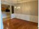 Elegant dining room featuring hardwood floors, wainscoting, and a chandelier at 125 Villa Park Cir, Stone Mountain, GA 30087