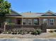 Inviting brick townhome featuring a decorative brick privacy wall and well-maintained yard at 125 Villa Park Cir, Stone Mountain, GA 30087