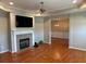 Open-concept living space featuring hardwood floors, fireplace and view of dining area at 125 Villa Park Cir, Stone Mountain, GA 30087