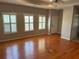 Bright living room featuring hardwood floors, plantation shutters, and neutral paint at 125 Villa Park Cir, Stone Mountain, GA 30087