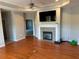 Cozy living room boasts hardwood floors and a fireplace with tile surround at 125 Villa Park Cir, Stone Mountain, GA 30087