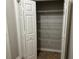 A bi-fold door opens to a pantry with wire shelving and a brown floor at 125 Villa Park Cir, Stone Mountain, GA 30087