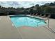 Community pool with plenty of lounge chairs and crystal clear water at 125 Villa Park Cir, Stone Mountain, GA 30087