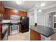 Modern kitchen with dark cabinetry, granite countertops, and stainless steel appliances at 400 17Th Nw St # 1253, Atlanta, GA 30318