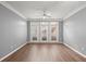 Bright living room featuring wood floors, ceiling fan, and sliding glass doors at 400 17Th Nw St # 1253, Atlanta, GA 30318